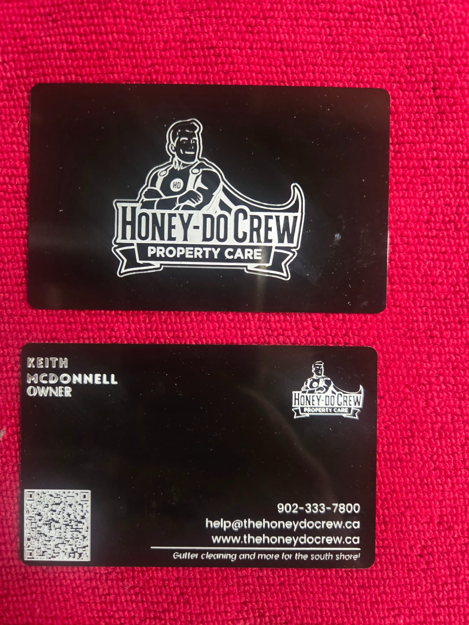 Front and back views of black anodized aluminium business cards